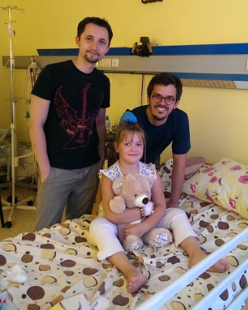 Photo of Dr. Luke Tomycz with patient and family in a hospital room
